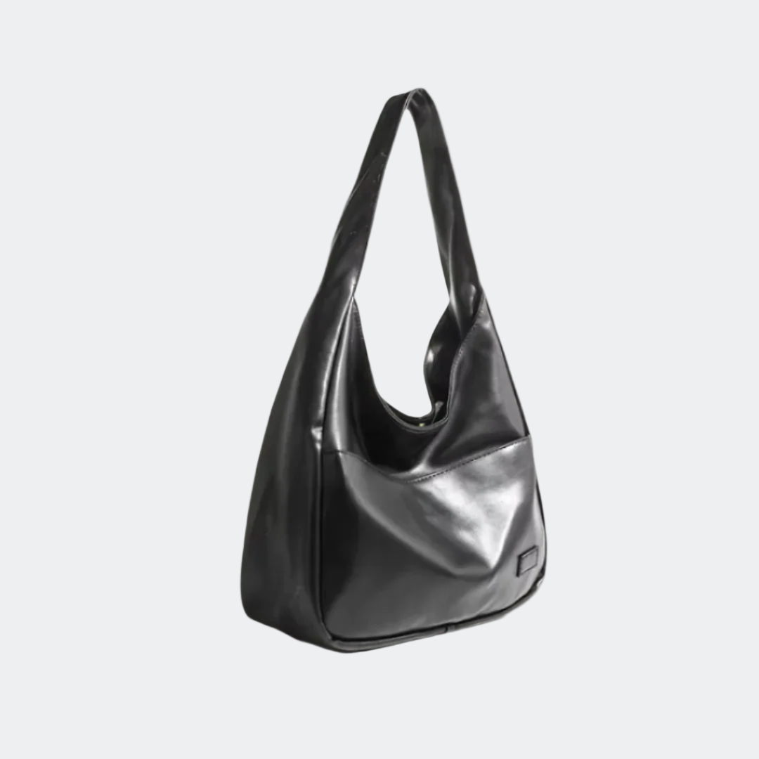 Black handbag on a light beige background