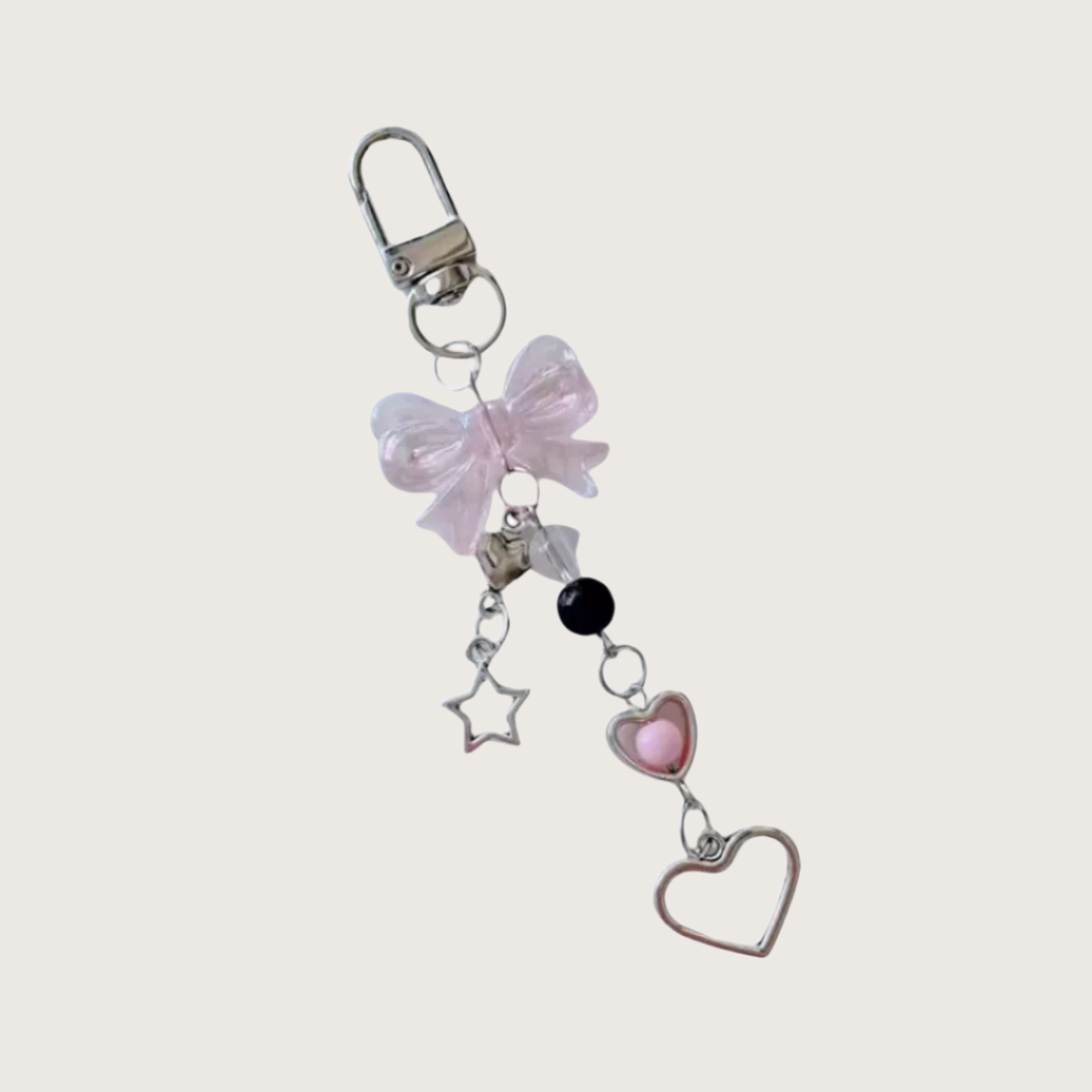 Keychain or bag charm with pink bow, heart, and star charms on a white background