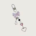 Keychain or bag charm with pink bow, heart, and star charms on a white background