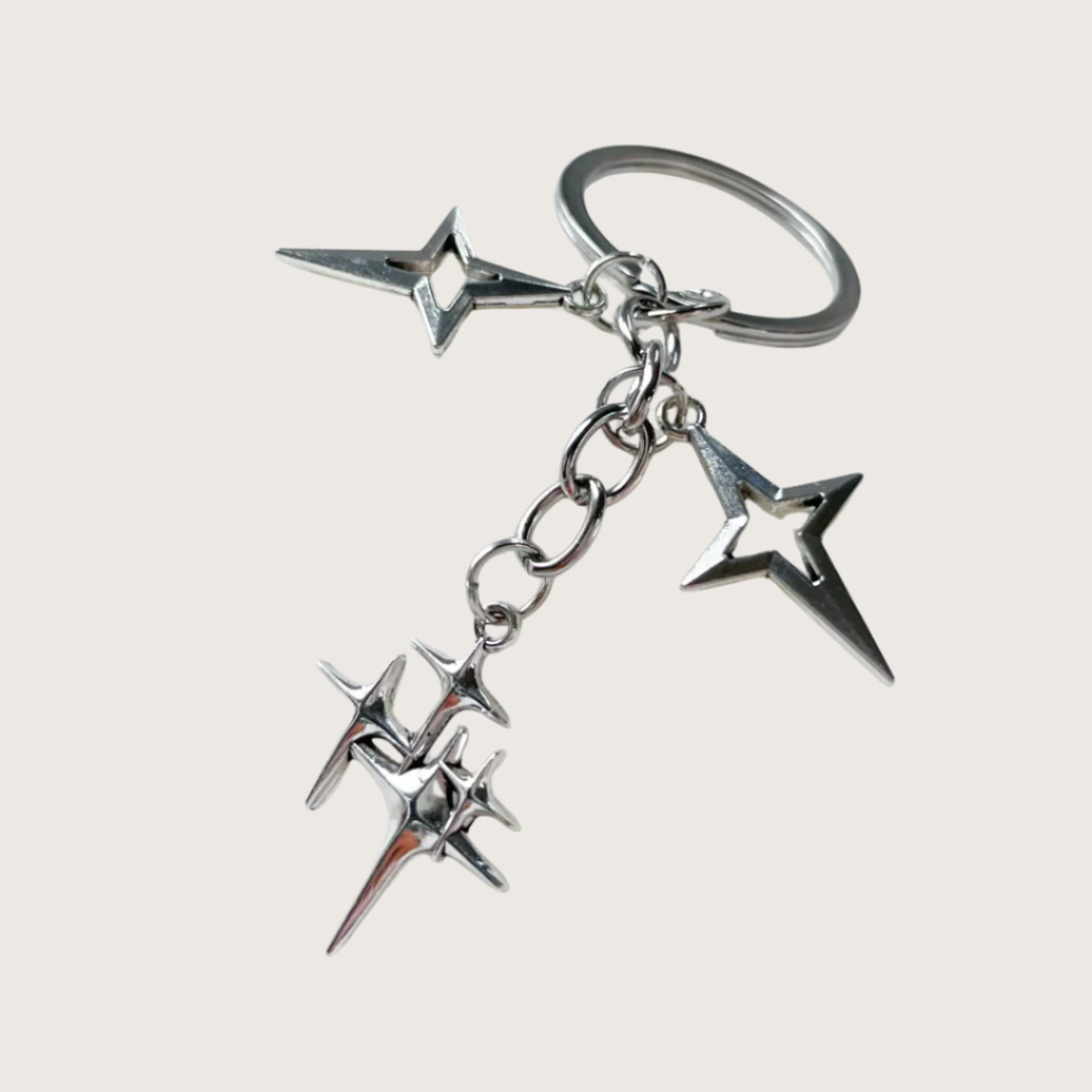 Silver star-shaped keychain or bag charm on a white background