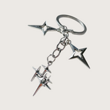Silver star-shaped keychain or bag charm on a white background