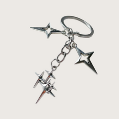 Silver star-shaped keychain or bag charm on a white background