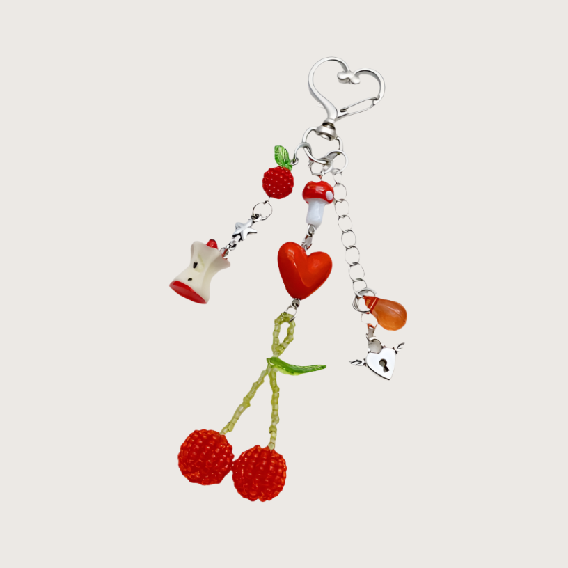 Fruit-themed keychain or bag charm with heart, fruit and mushroom.
