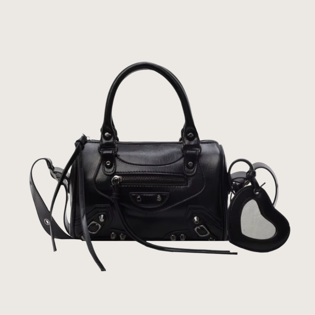 Black handbag with a heart-shaped mirror on a white background