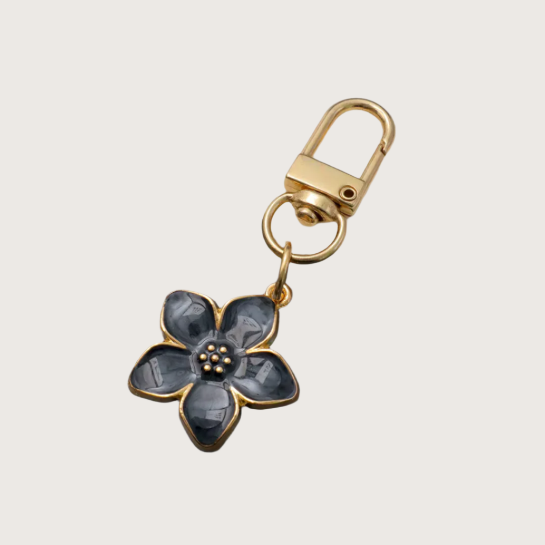 Black Floral keychain or bag charm with gold accents.