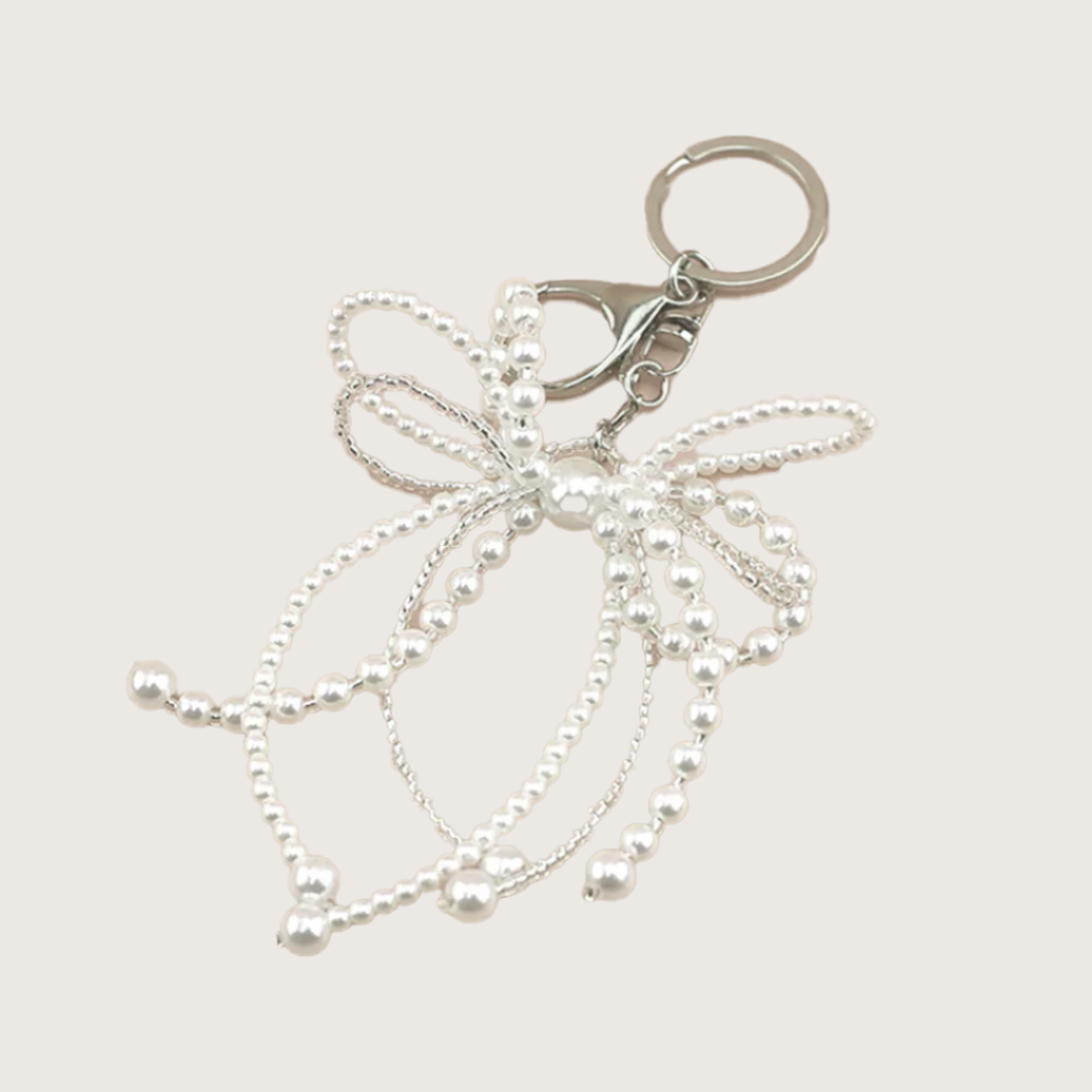 Keychain or bag charm with pearls and a bow out of pearls.