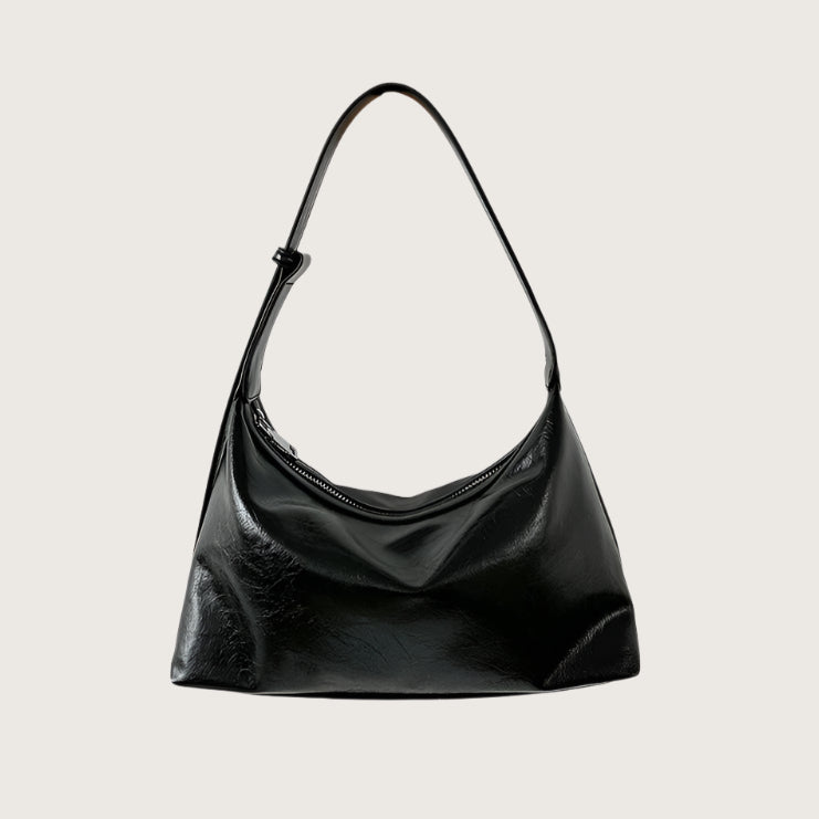 Black smaller handbag on a white background