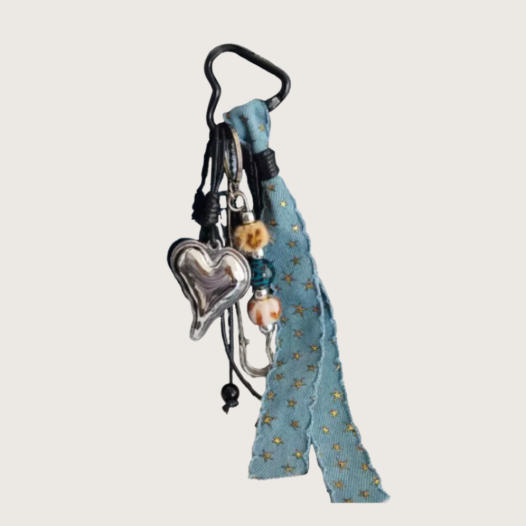 Keychain or bag charm with silver heart charm and denim ribbon with small details.