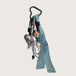 Keychain or bag charm with silver heart charm and denim ribbon with small details.