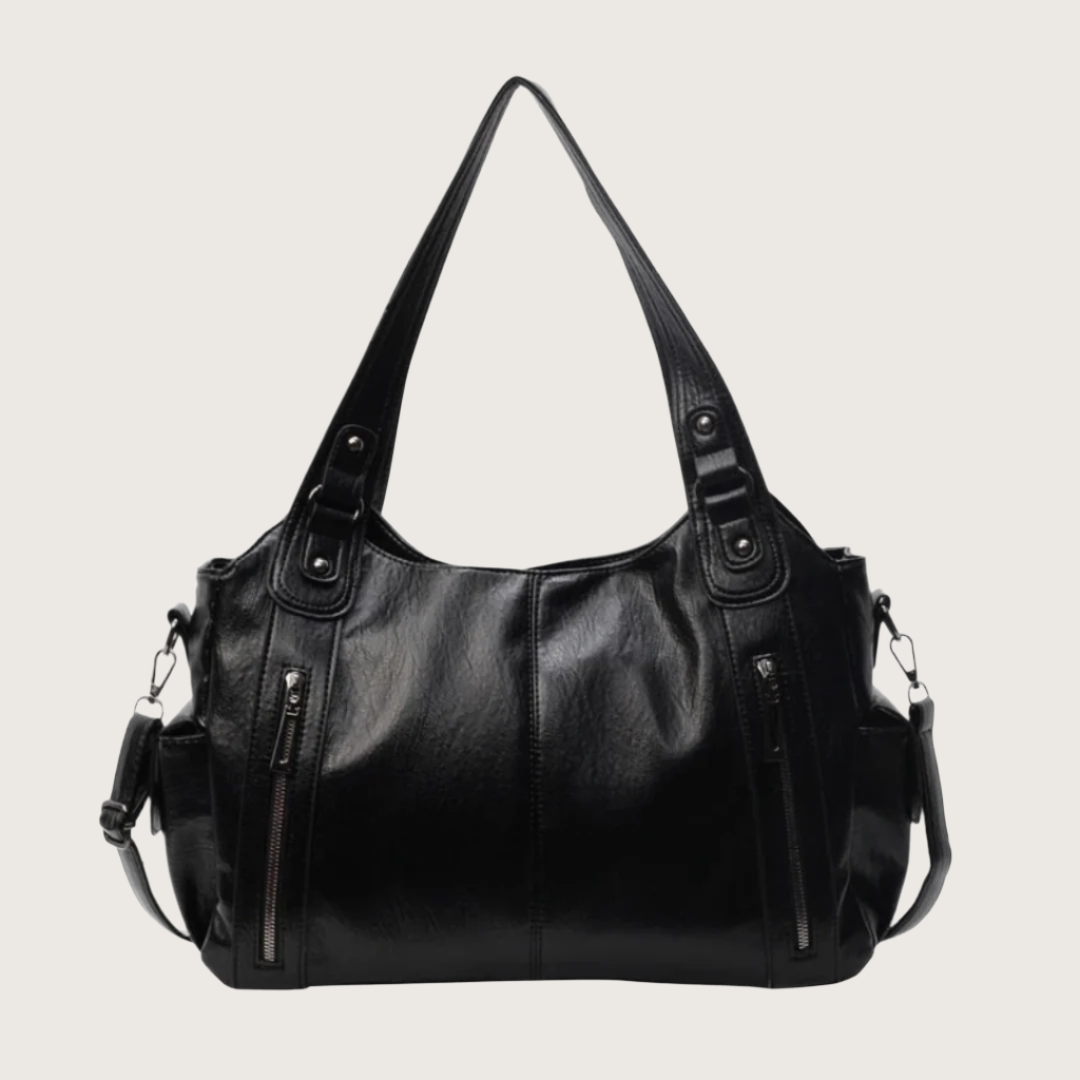 Black leather handbag with multiple zippers on a white background