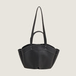 Black handbag with a strap on a white background