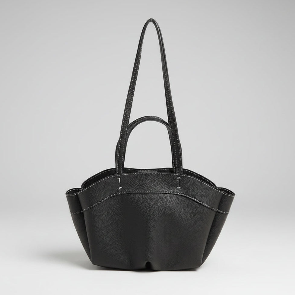 Black handbag with a strap on a white background