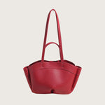 Red handbag with a strap on a white background